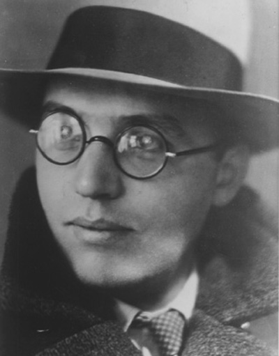 Black and white photo of man wearing glasses and hat